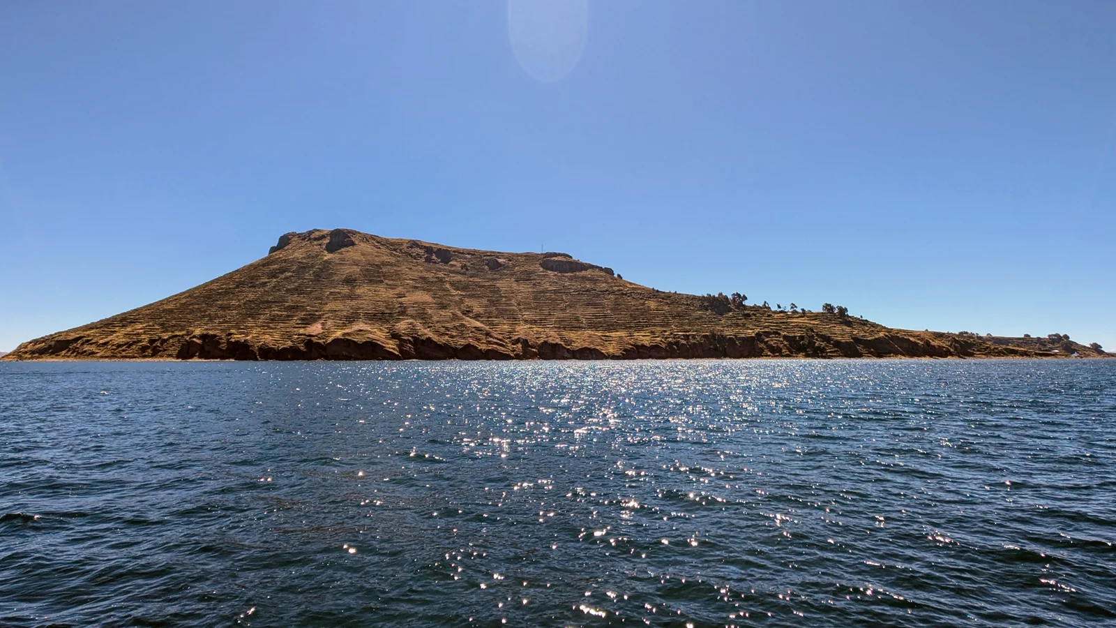 Amantaní island above the deep blue water of Lake Titicaca.